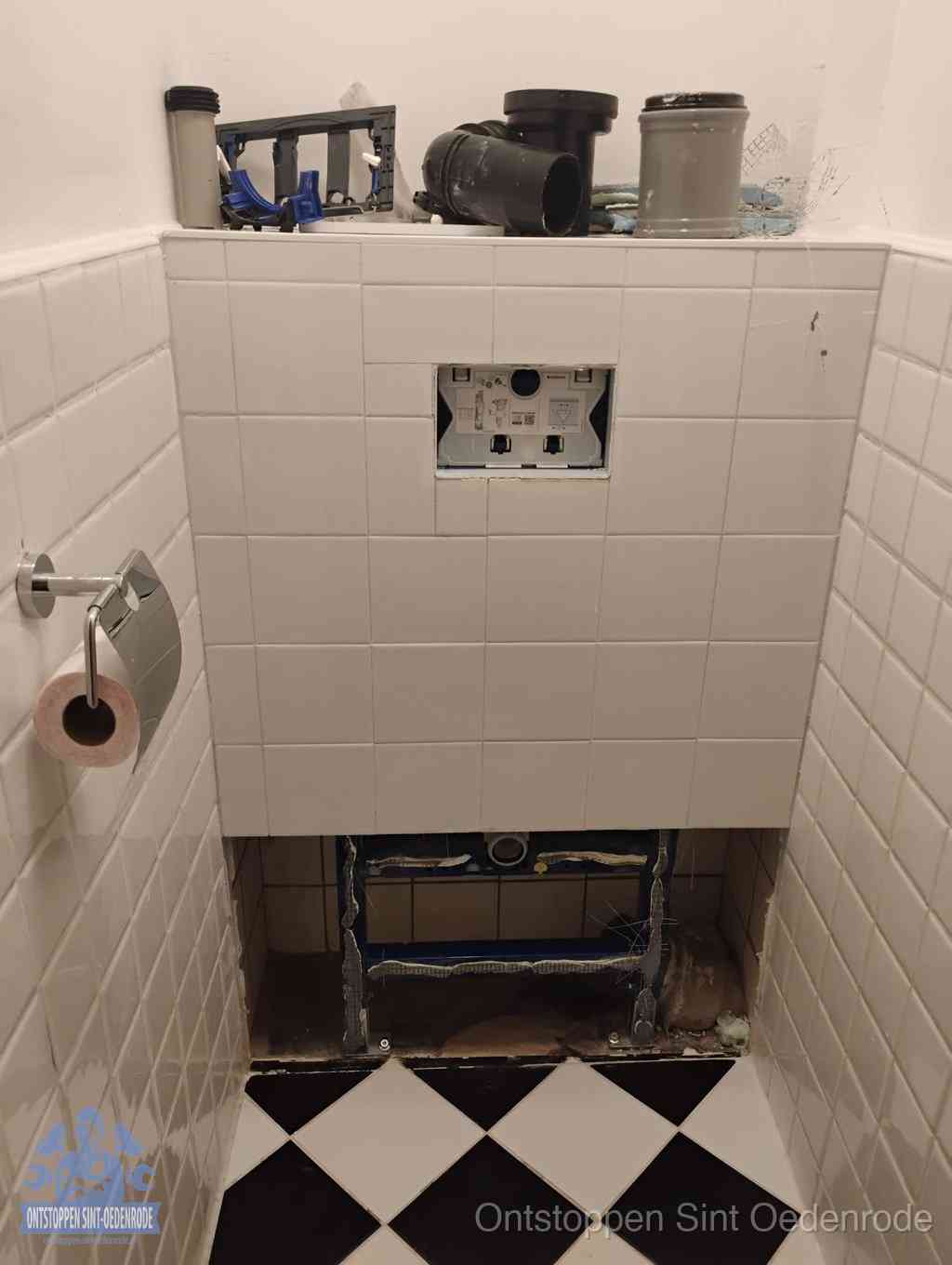 Een toiletruimte waar het hangtoilet en de inbouwreservoir-onderdelen zijn vrijgelegd voor onderhoud, periodiek nazicht voorkomt een wc-verstopping in Sint Oedenrode
